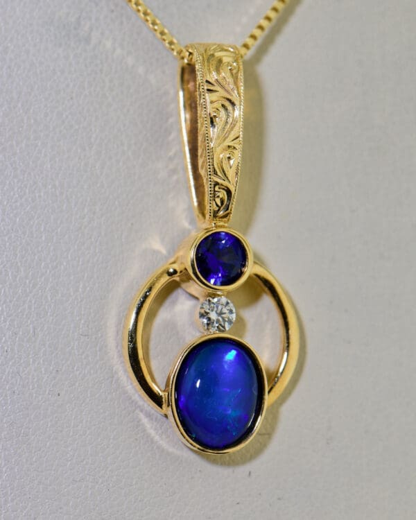 amazing custom gold pendant with blue black opal and blue sapphire