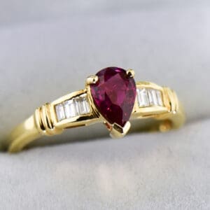 modern estate pear shape ruby ring with baguette diamond accents 2