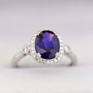 oval halo engagement ring with rare blue purple sapphire