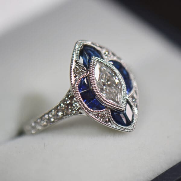 art deco style navette ring with marquise diamond and calibre sapphires 4