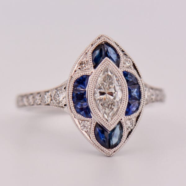 art deco style navette ring with marquise diamond and calibre sapphires