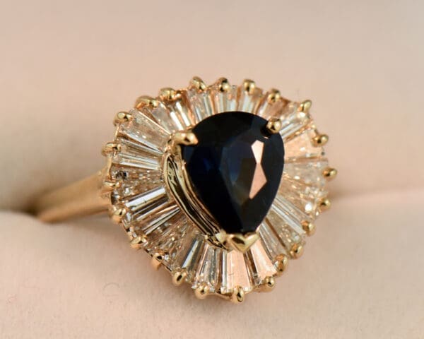 dark blue pear shape sapphire and baguette diamond ballerina ring