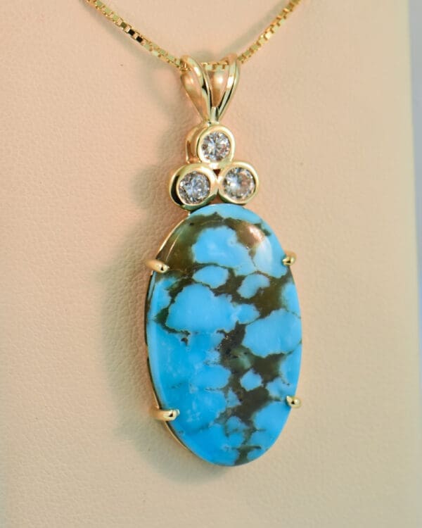 large kingman turquoise and diamond pendant set in yellow gold