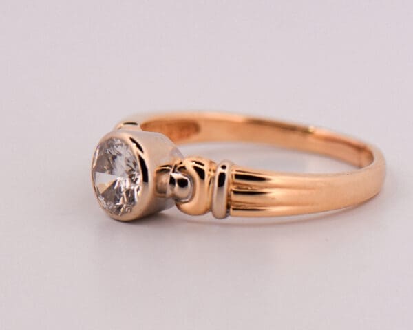 1ct round diamond bezel set solitaire engagement ring in two tone gold 3