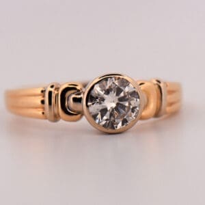 1ct round diamond bezel set solitaire engagement ring in two tone gold