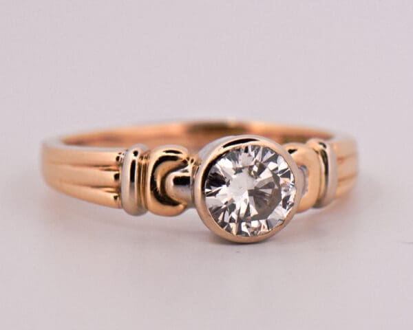 1ct round diamond bezel set solitaire engagement ring in two tone gold 4