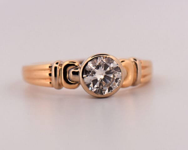 1ct round diamond bezel set solitaire engagement ring in two tone gold