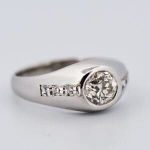 art deco unisex diamond ring with bezel set euro cut diamond and carre cut accents