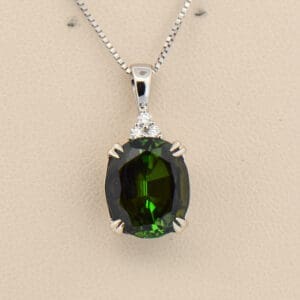 large dichroic deep green tourmaline and diamond pendant