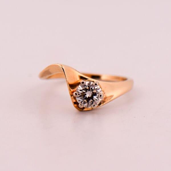 mid century curved gold engagement ring with half carat diamond