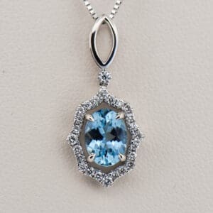 oval aquamarine and diamond halo pendant