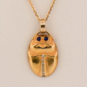 antique egyptian revival gold scarab pendant with sapphires and diamonds