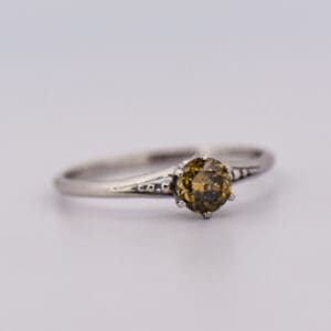 antique platinum solitaire ring with fancy kahki green diamond