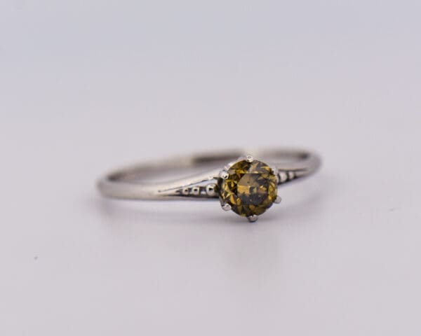 antique platinum solitaire ring with fancy kahki green diamond