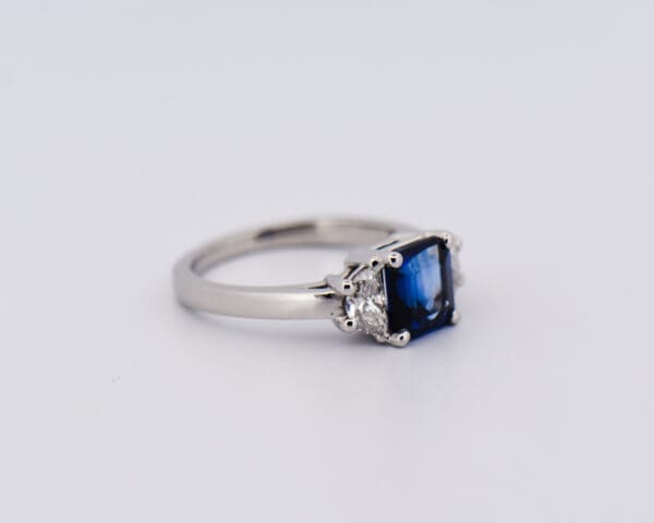 asscher cut blue sapphire and half moon diamond three stone ring 2