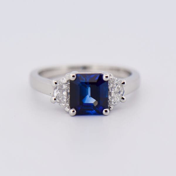 asscher cut blue sapphire and half moon diamond three stone ring 5