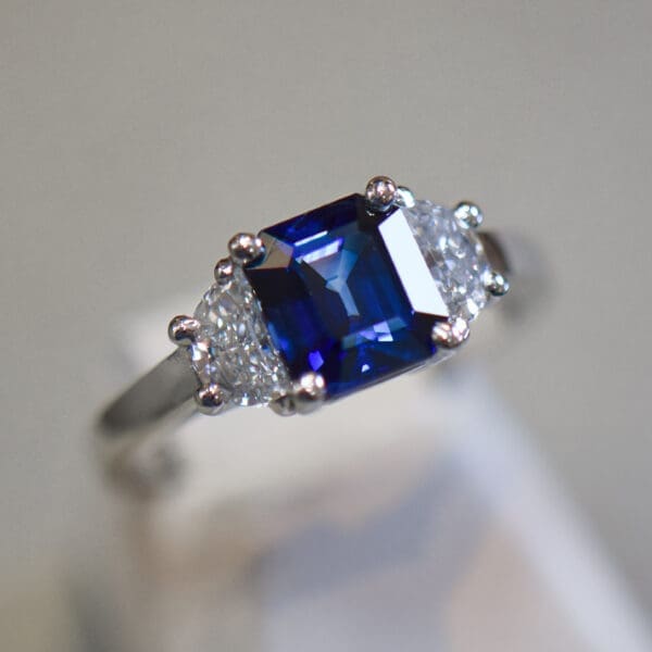 asscher cut blue sapphire and half moon diamond three stone ring 6