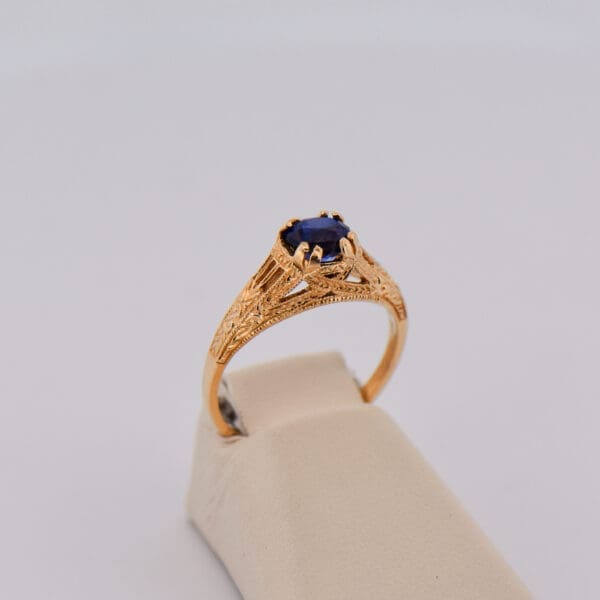 vintage inspired yellow gold filigree ring with blue sapphire