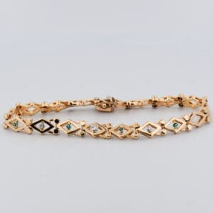 vintage yellow gold geometric link bracelet with emeralds and diamonds