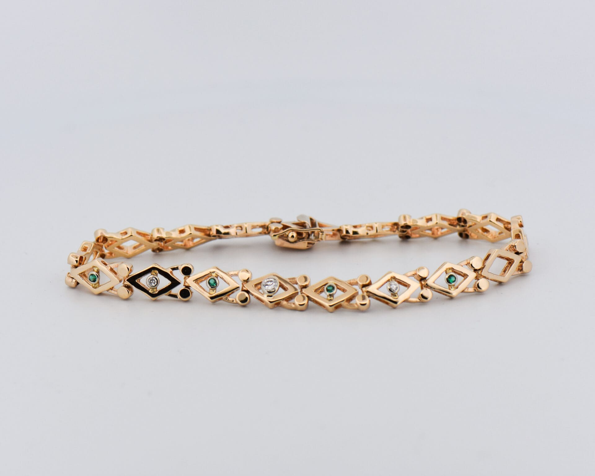 vintage yellow gold geometric link bracelet with emeralds and diamonds